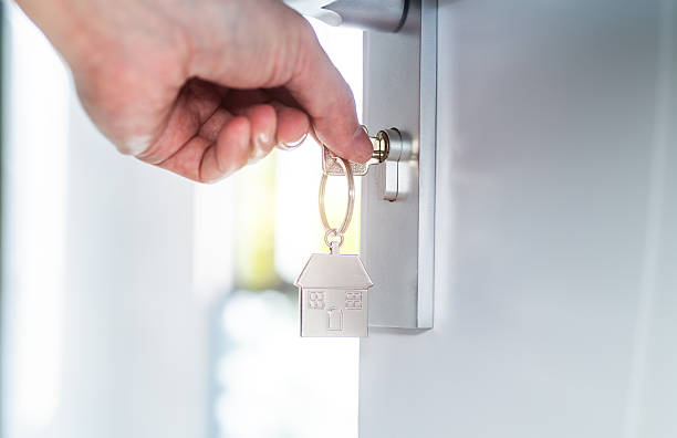human hand opening a door with key